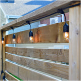 Light chain set MIMOSA2 attached to wooden fence, creating ambient outdoor lighting suitable for outdoor use